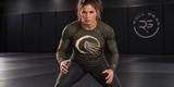 Roll Gear Phantom Pressure long sleeve rash guard, olive, worn by female grappler in ready stance