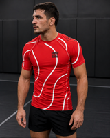 Roll Gear Red with White Lines Rash Guard – Short Sleeve, worn by a male athlete with black shorts.
