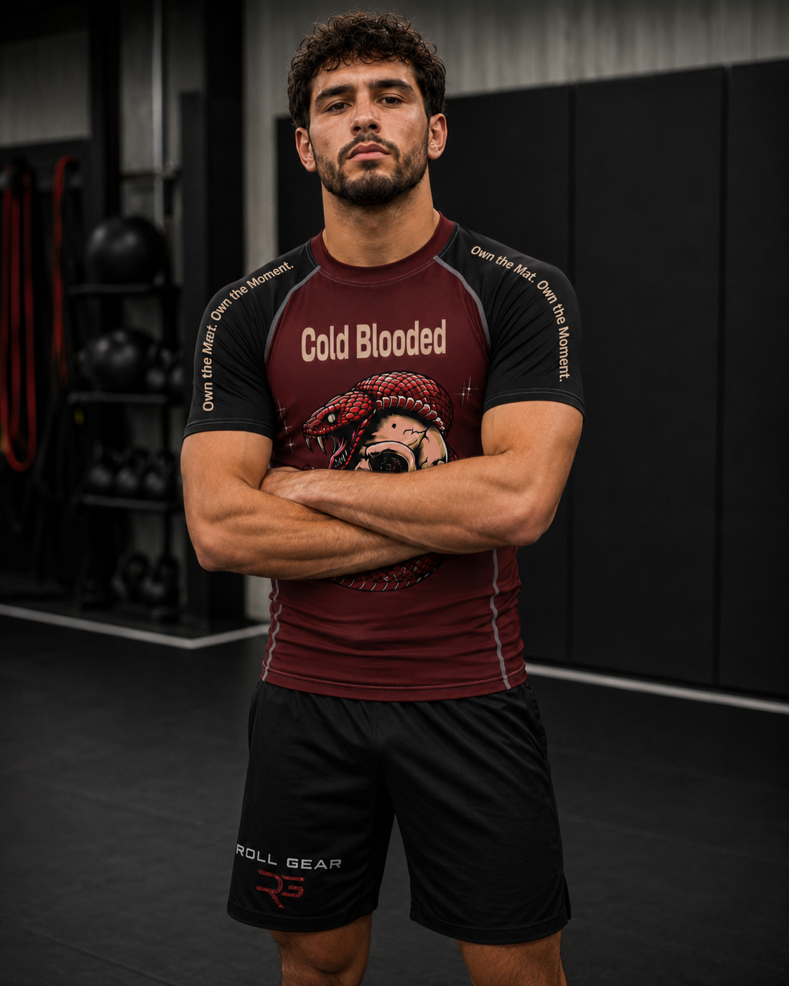 Roll Gear Cold Blooded Rash Guard – Maroon Venom Athlete Edition, front view, arms crossed, Cold Blooded chest print.