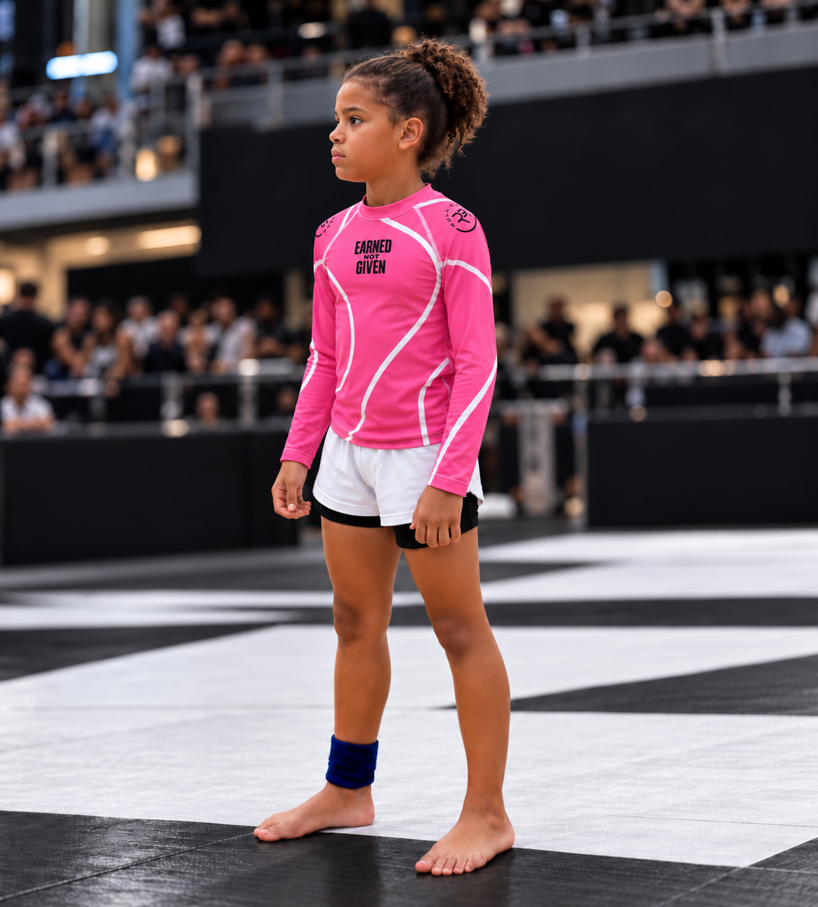Roll Gear Kids Pink Long Sleeve Rash Guard, young girl walking onto a competition mat.