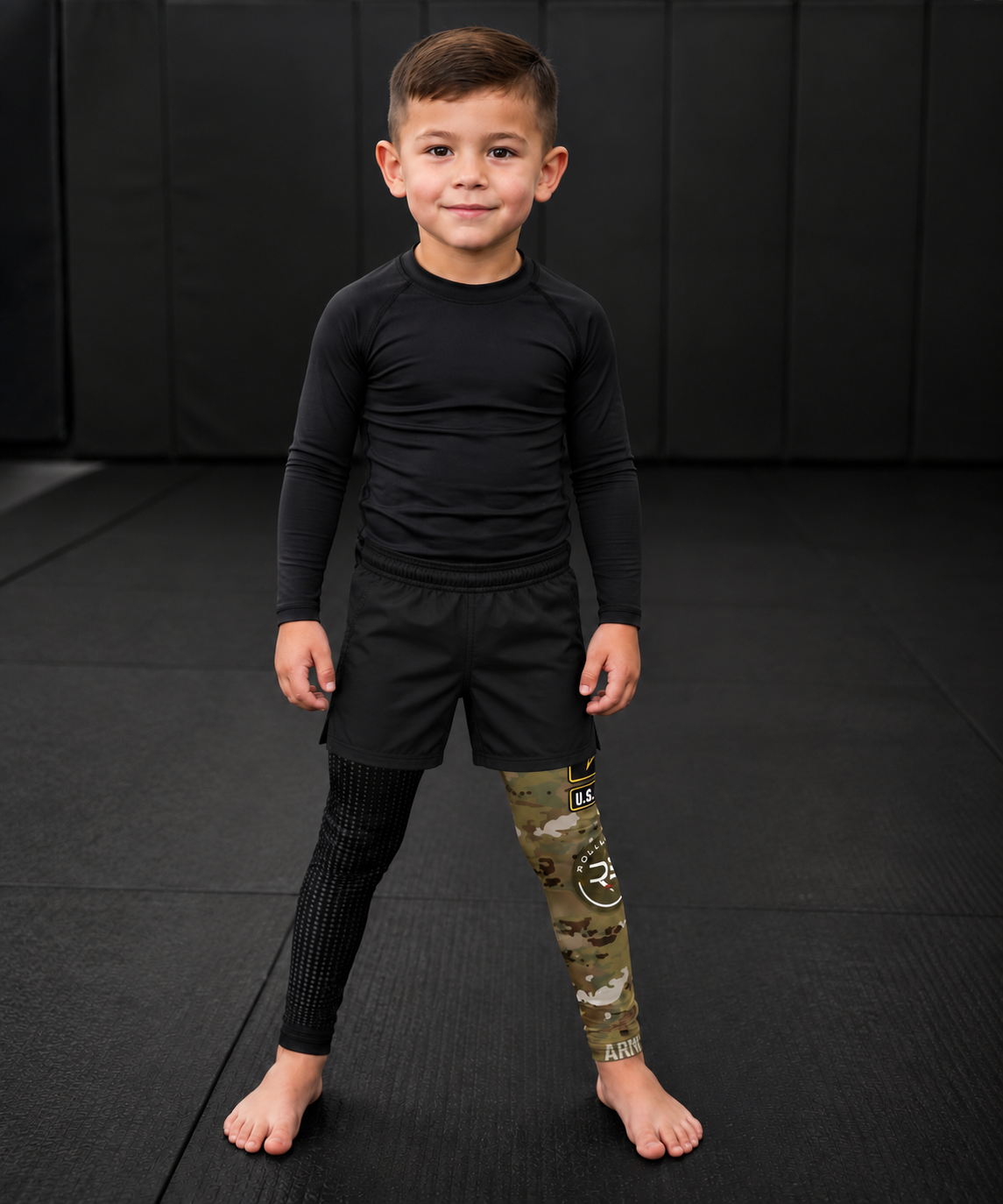 Roll Gear Kids Army Compression Spats – Black Camo, front view on a young boy.
