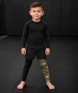 Roll Gear Kids Army Compression Spats – Black Camo, front view on a young boy.