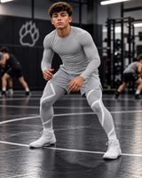Roll Gear Grey Swirl Spats – Grey/White – Youth, teen boy in a wrestling stance in the gym.