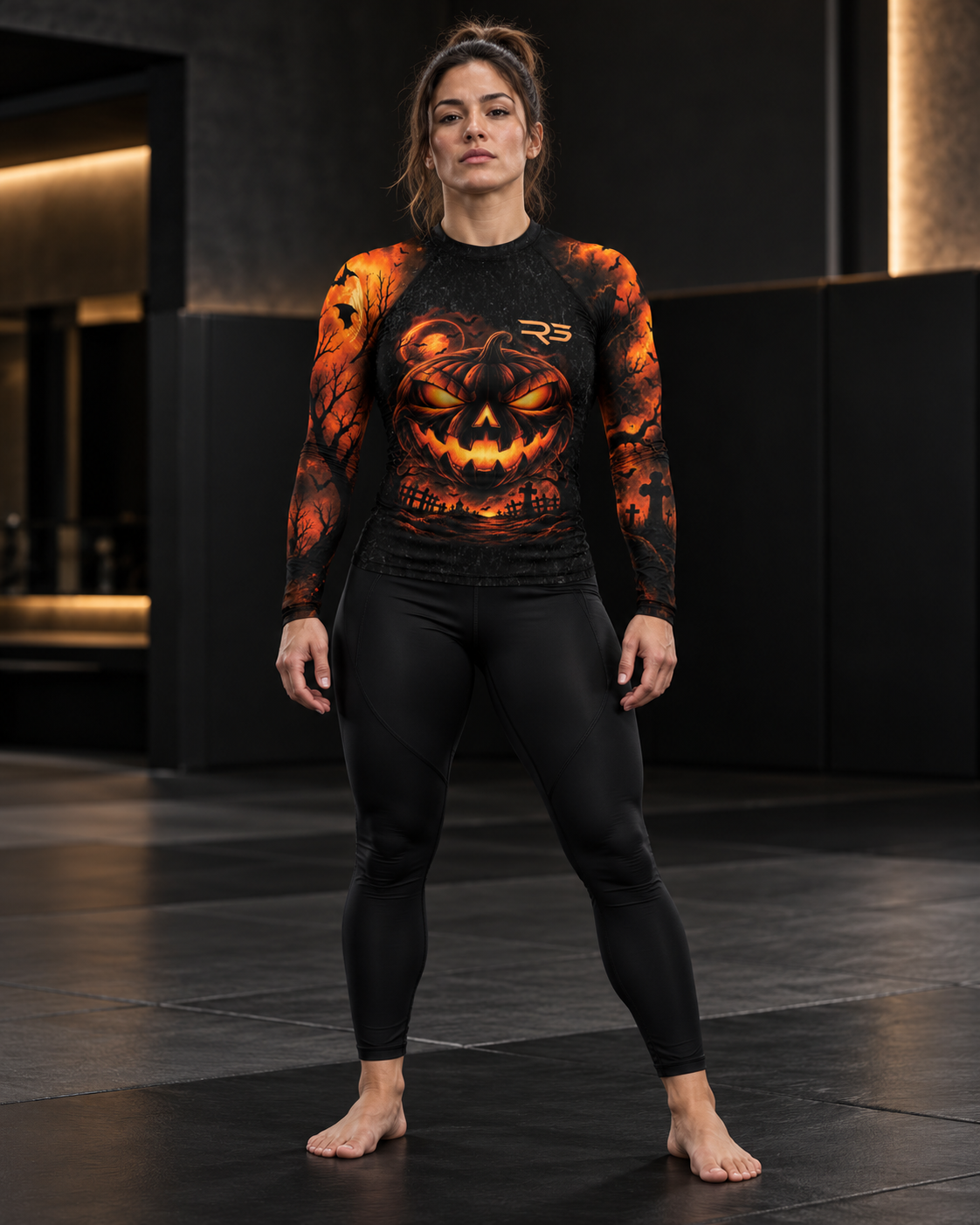 Roll Gear Women's Tap or Treat Long Sleeve Rash Guard, front view, jack-o'-lantern print.