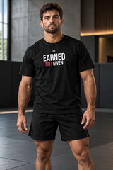 Roll Gear Men’s Earned Not Given T-Shirt, front view, worn with training shorts in the gym.