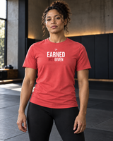 Roll Gear Women's Earned Not Given Motivational T-Shirt, front view, worn with leggings in the gym.