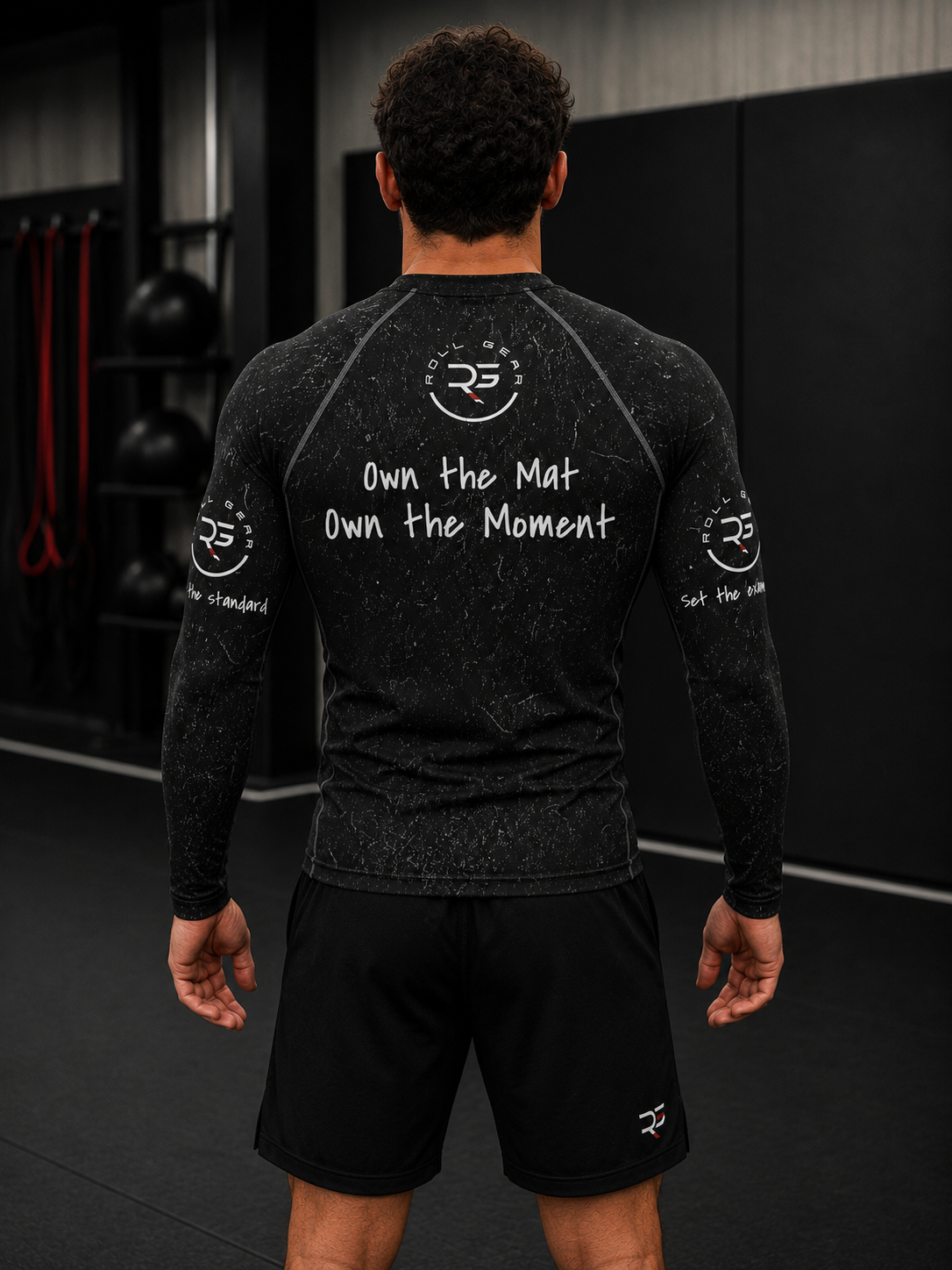 Roll Gear Tap Hype Rash Guard, back view, Own the Mat Own the Moment back text.