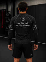 Roll Gear Tap Hype Rash Guard, back view, Own the Mat Own the Moment back text.