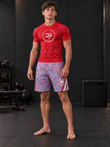 Roll Gear Stars & Scribbles Grappling Shorts – Boys', teen boy in a red top standing in a gym.