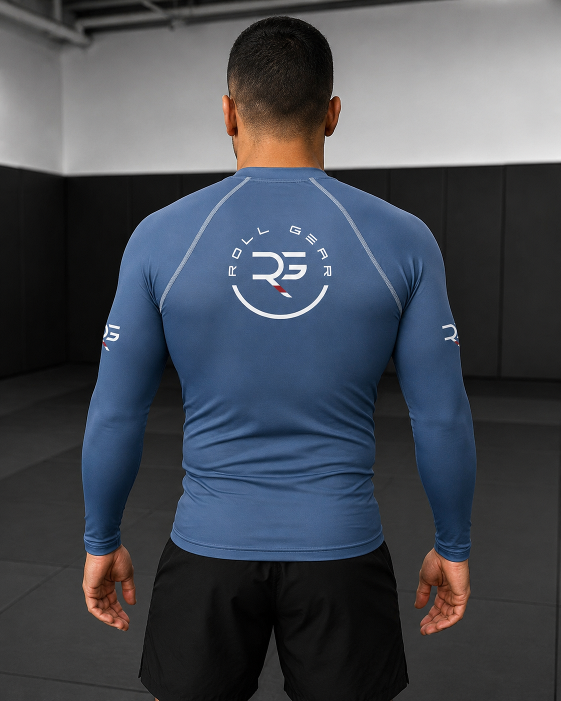 Roll Gear Earned Not Given Long Sleeve Rash Guard – Blue – Men’s, back view showing the Roll Gear emblem.
