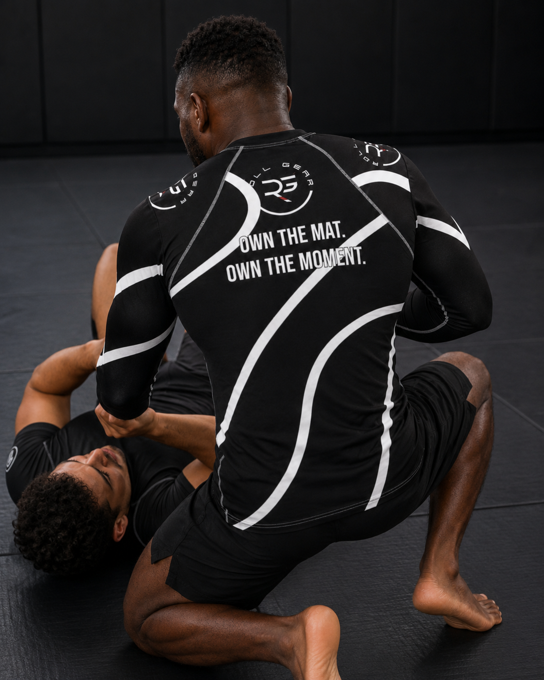 Roll Gear Black Swirl Long Sleeve Rash Guard – Black/White – Men’s, back view, Own the Mat back text, worn in top position.