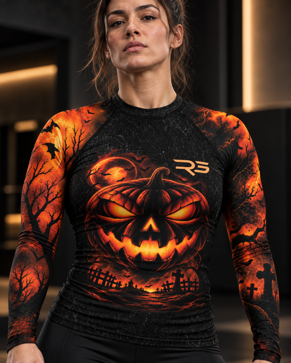 Roll Gear Women's Tap or Treat Long Sleeve Rash Guard, close-up of the jack-o'-lantern chest print.