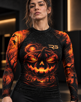 Roll Gear Women's Tap or Treat Long Sleeve Rash Guard, close-up of the jack-o'-lantern chest print.