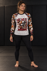 Roll Gear Never Accept Rash Guard – Black – Women’s, front view, skull graphic and tattoo-style sleeves.