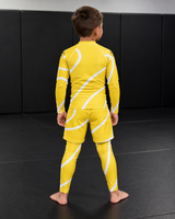 Roll Gear Yellow Swirl Spats – Yellow/White – Kids, back view on a child in the matching rash guard.