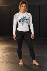 Roll Gear Tap Hype Rash Guard – Blue/White – Women's, front view, worn with leggings on the mat.