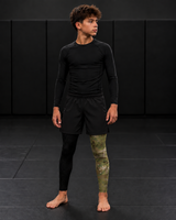 Roll Gear Youth Army Compression Spats – Black Camo, worn under shorts by a youth athlete on the mat.