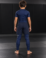Roll Gear Youth Air Force Compression Spats – Navy, back view on a boy.