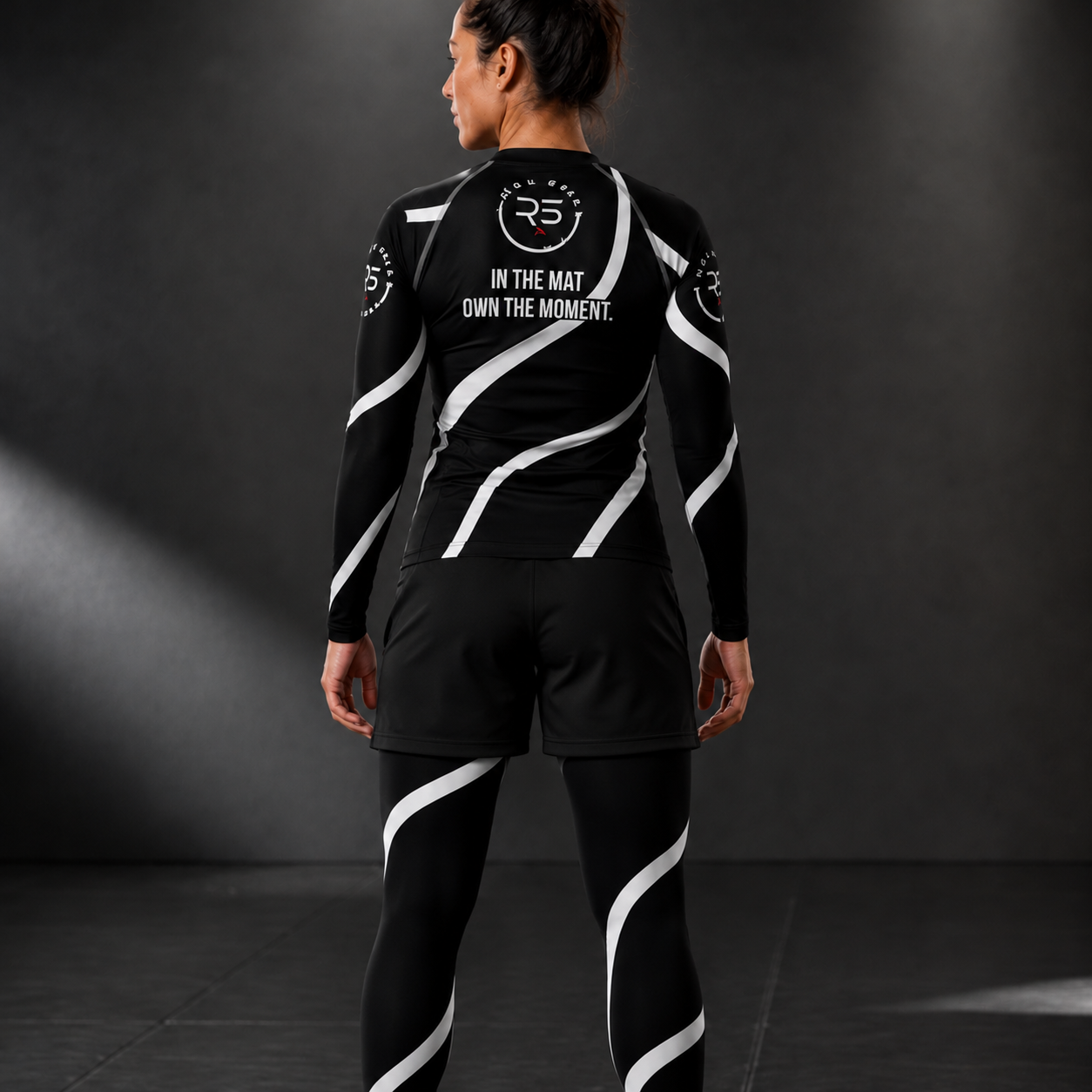 Roll Gear Black Swirl Rash Guard – Black/White – Women’s, back view on a woman wearing matching spats.