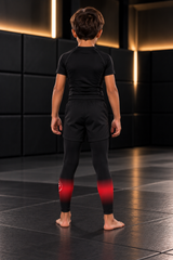 Roll Gear Black Fade Training Spats – Black/Grey – Kids, back view on a boy.