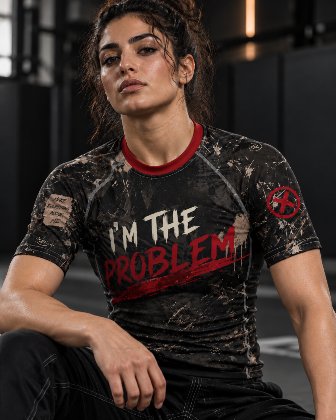 Roll Gear I'm the Problem Short Sleeve Rash Guard – Adult Unisex, close-up, female athlete seated.