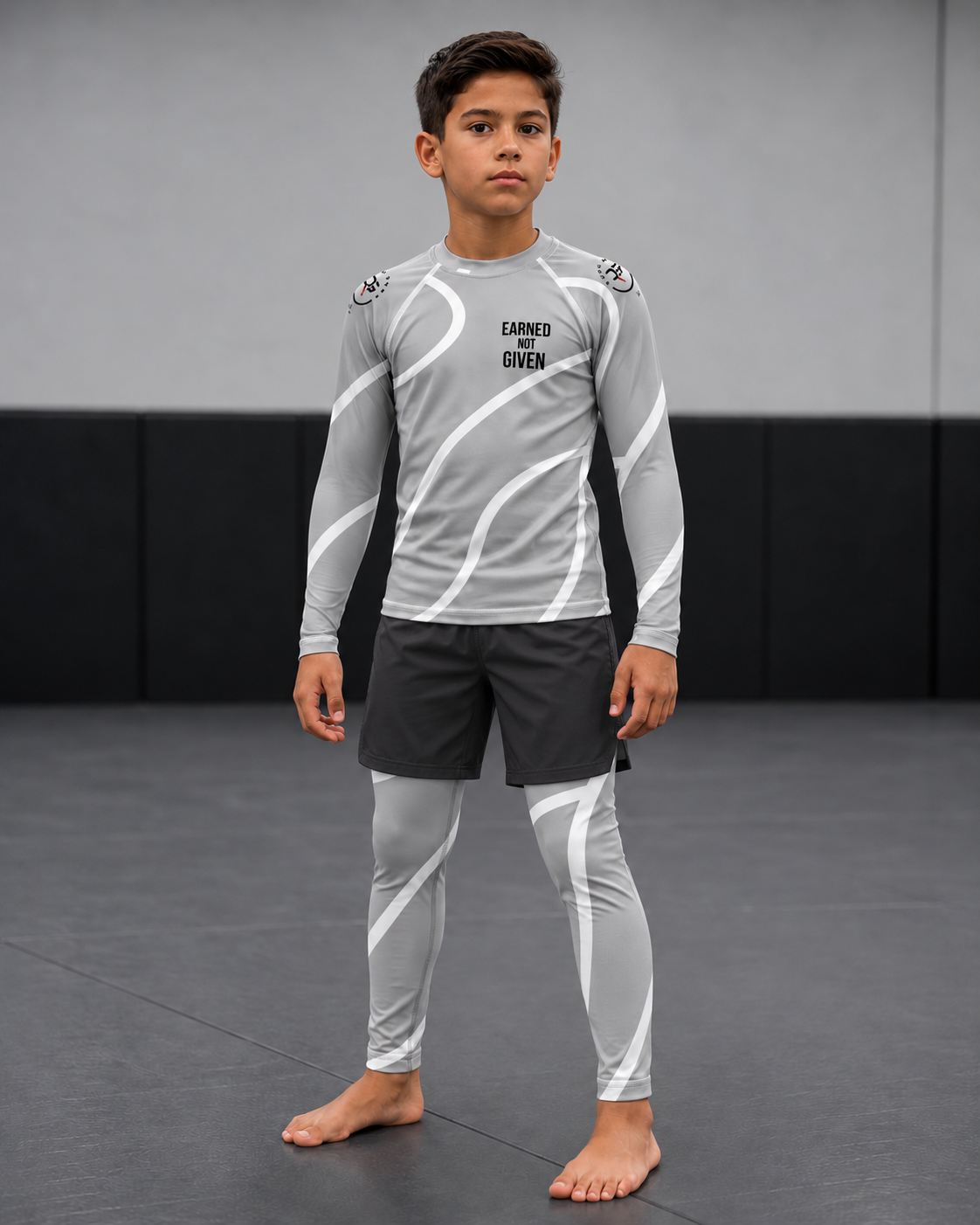 Roll Gear Grey Swirl Spats – Grey/White – Kids, front view on a boy wearing the matching rash guard.