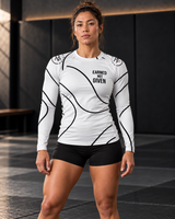 Roll Gear White Swirl Rash Guard – White/Black – Women’s, front view on a woman standing on the mat.