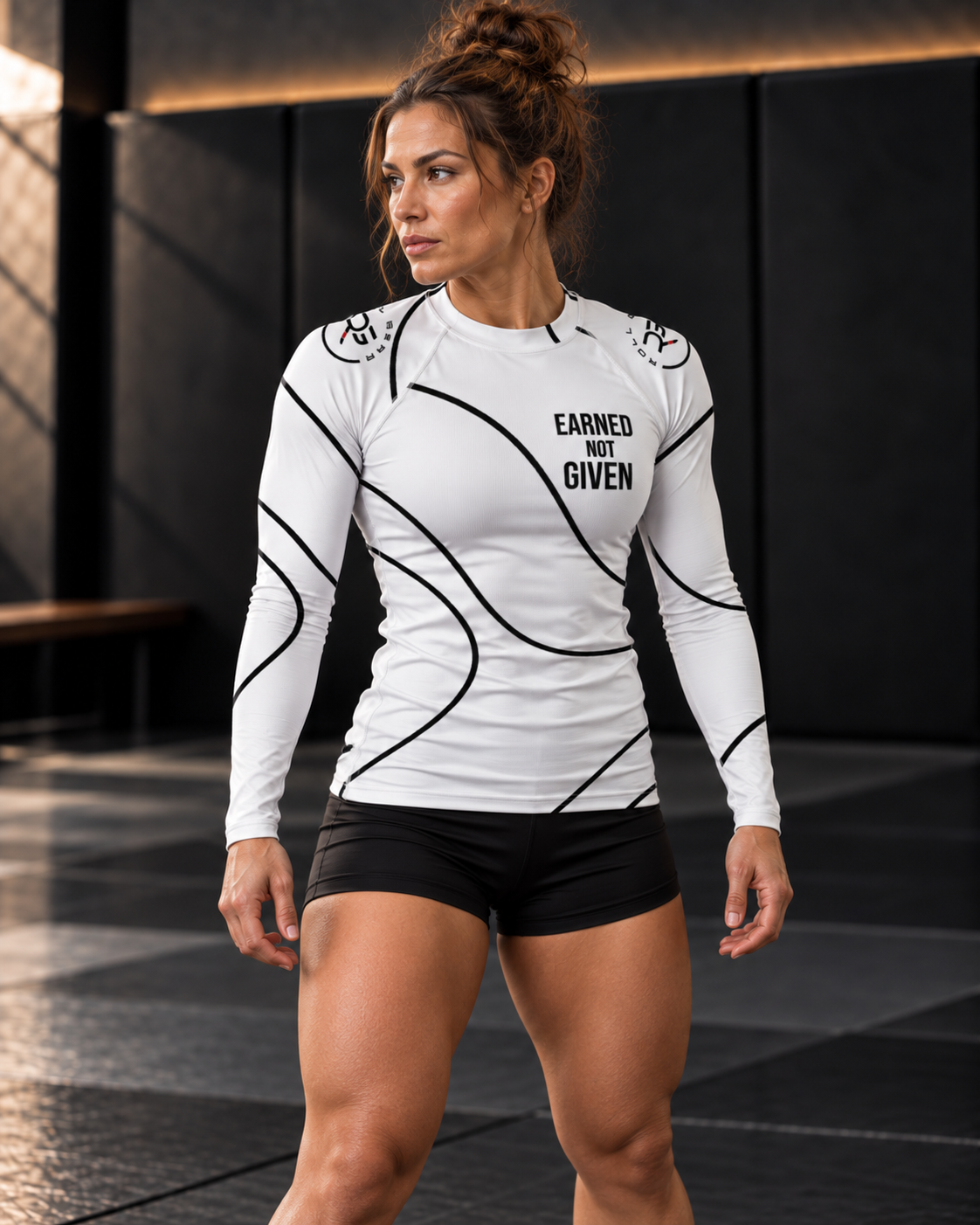 Roll Gear White Swirl Rash Guard – White/Black – Women’s, worn by a woman turning on the mat.