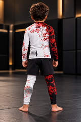 Roll Gear Shadow Dragon Warrior Kids Rash Guard and Spats – White & Crimson, boy standing on the mat, back view.