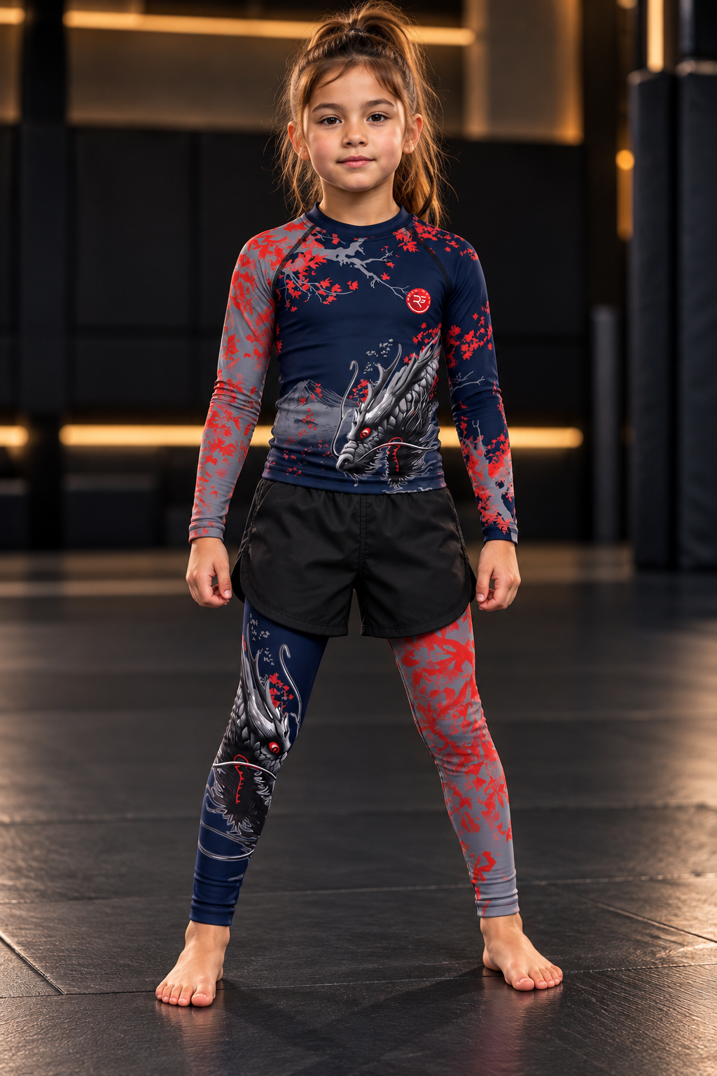 Roll Gear Shadow Dragon Warrior Rash Guard – Dark Navy & Crimson – Kids Long Sleeve, girl in the matching set, front view.