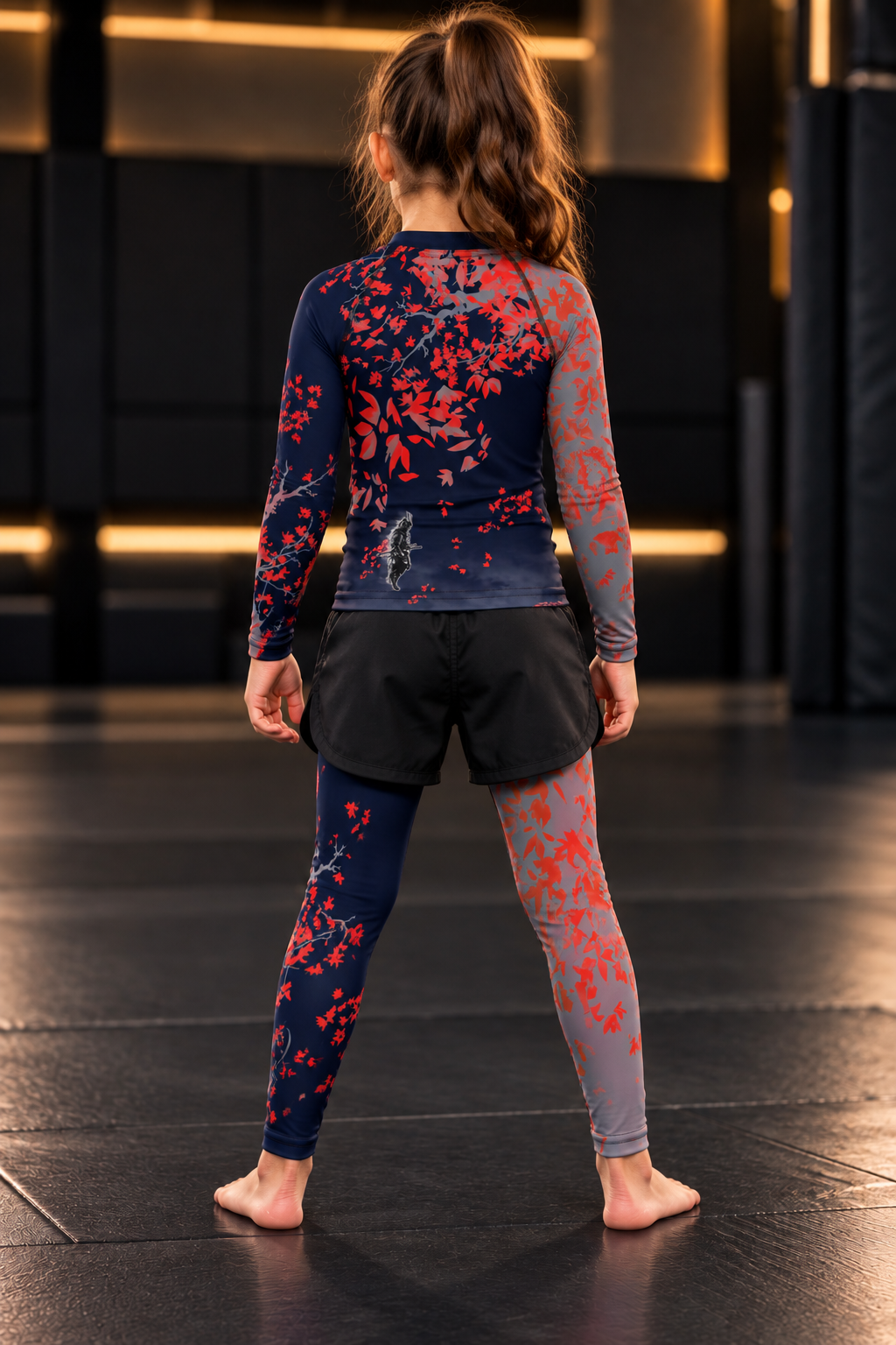 Roll Gear Shadow Dragon Warrior Rash Guard – Dark Navy & Crimson – Kids Long Sleeve, girl in the matching set, back view.