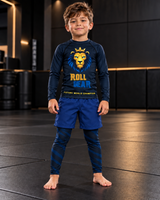 Roll Gear Kids Lion Rash Guard – Future World Champion, boy standing in the matching set, front view.