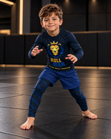 Roll Gear Kids Lion Rash Guard – Future World Champion, boy in a fighting stance on the mat.