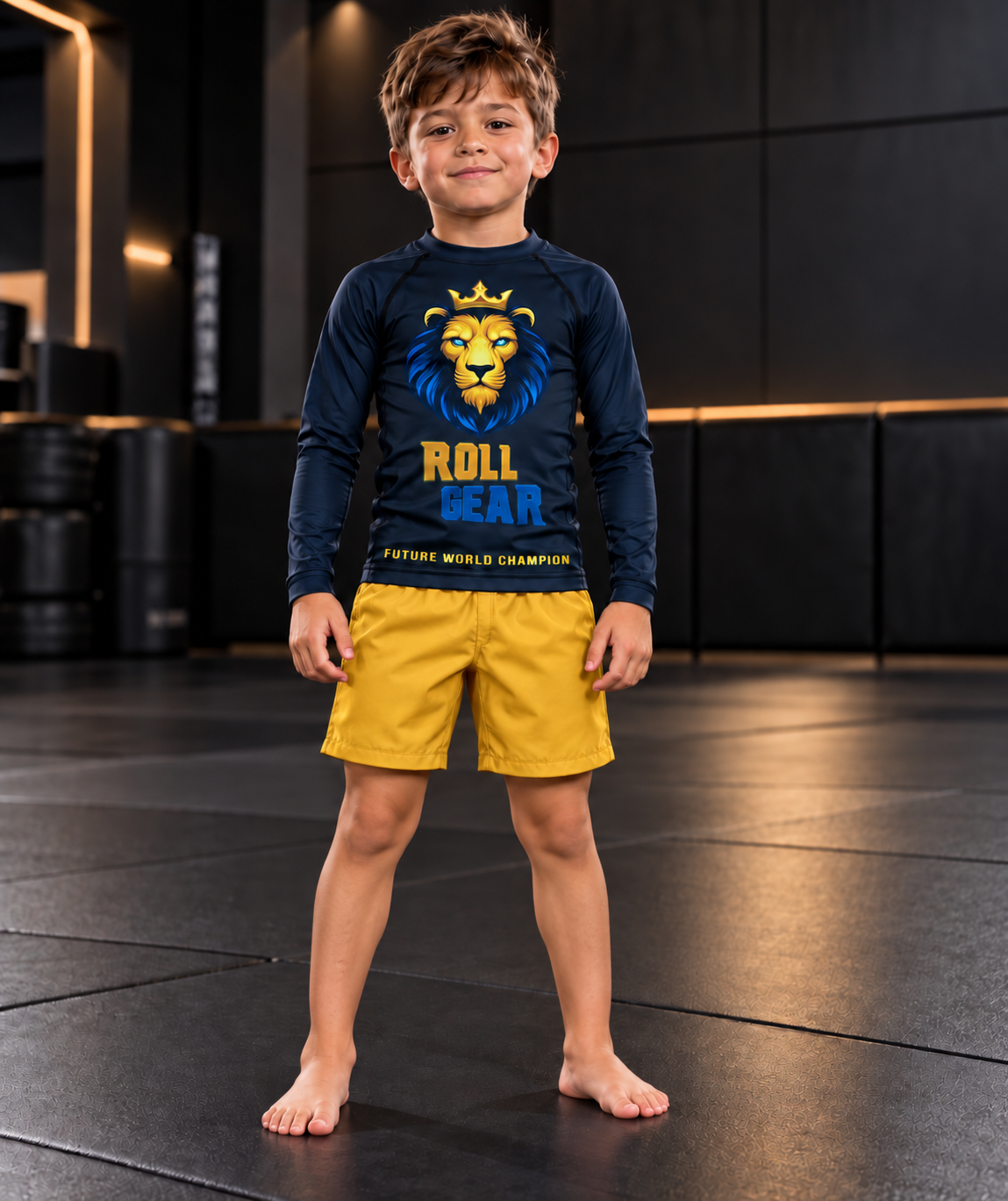 Roll Gear Kids Lion Rash Guard – Future World Champion, boy standing on the mat in yellow shorts.