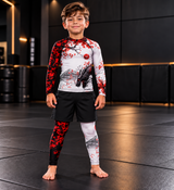 Roll Gear Shadow Dragon Warrior Spats – White & Crimson – Kids, boy standing in the matching set, front view.