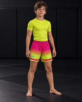 Roll Gear Neon Lava Grappling Shorts – Boys', front view, worn by a young athlete on the mat.