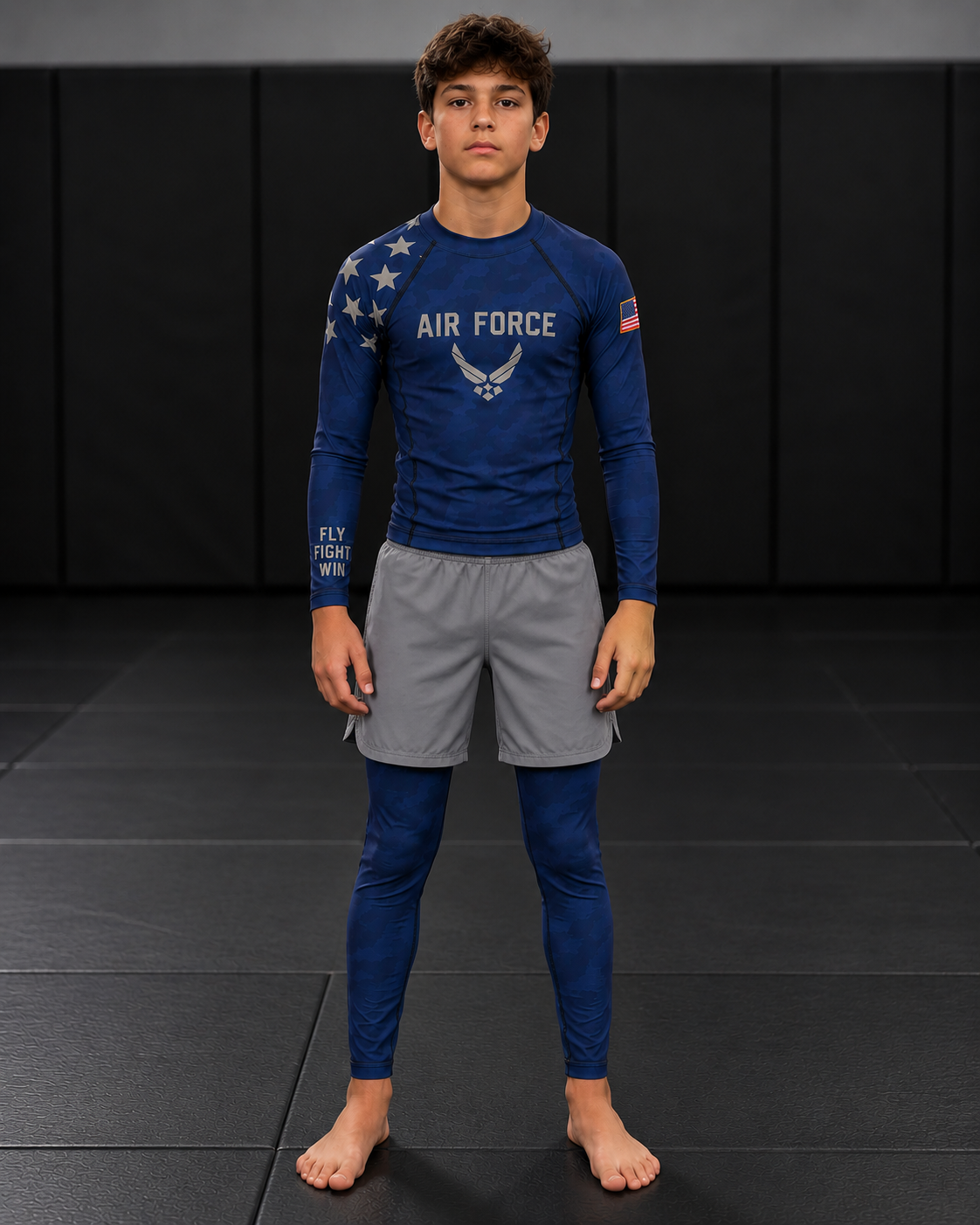 Roll Gear Youth Navy Compression Spats, worn under shorts by a youth athlete on the mat.