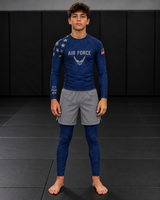 Roll Gear Youth Navy Compression Spats, worn under shorts by a youth athlete on the mat.