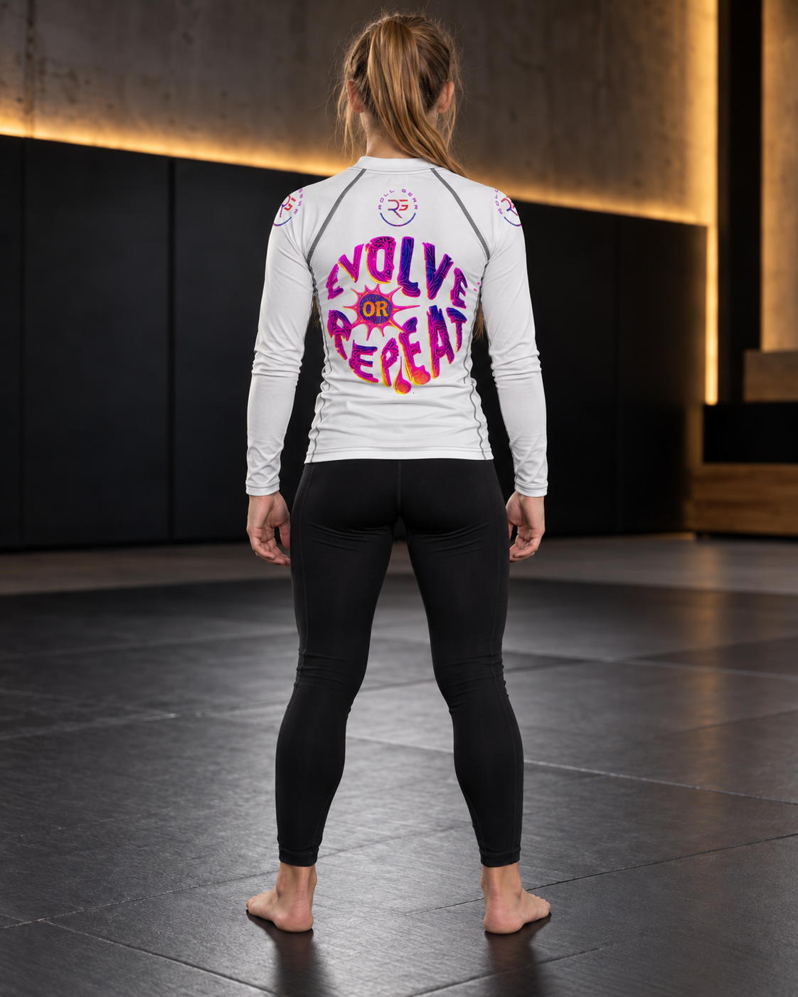 Roll Gear Evolve or Repeat Youth Girls Rash Guard – White, back view, Evolve or Repeat back graphic.