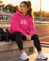 Roll Gear Tap Hype Hoodie – White Print, worn seated on a bench beside an outdoor track.