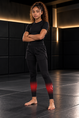 Roll Gear Black Fade Training Spats – Black/Grey – Youth, front view on a teen girl with arms crossed.