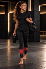 Roll Gear Black Fade Training Spats – Black/Grey – Youth, teen girl walking with a gym bag.