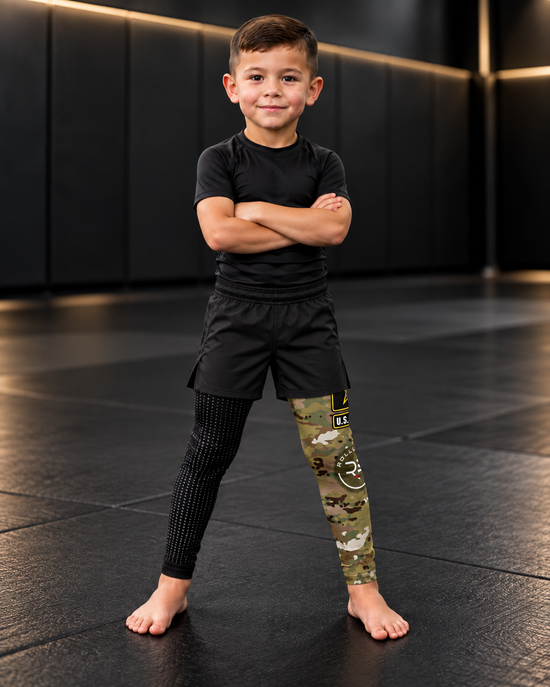 Roll Gear Kids Army Compression Spats – Black Camo, young boy with arms crossed.