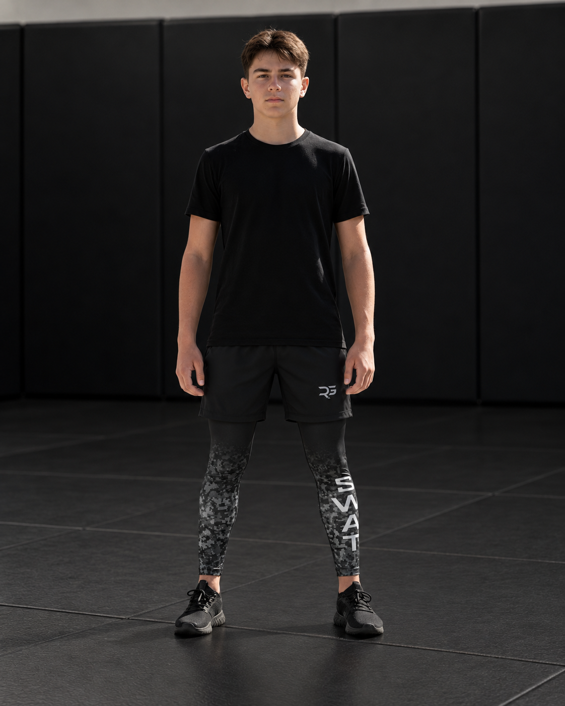 Roll Gear Youth SWAT Compression Spats, SWAT lettering down the leg, worn by a youth athlete on the mat.