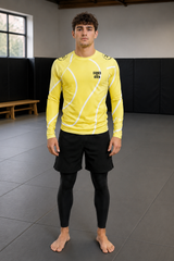 Roll Gear Yellow with White Lines Performance Rash Guard, front view, white swirl lines, worn with spats on the mat.