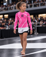 Roll Gear Kids Pink Long Sleeve Rash Guard, young girl walking across the competition mat.