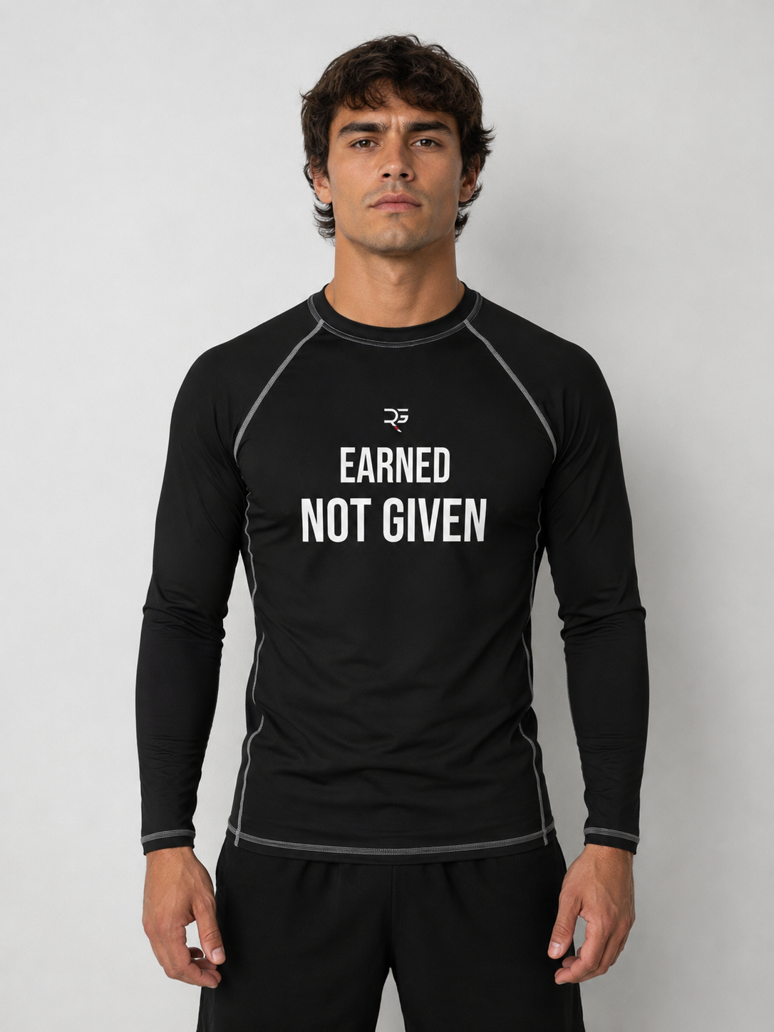 Roll Gear Excuses Don’t Burn Calories Rash Guard – Black – Men’s, front view, Earned Not Given chest text.