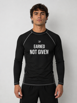 Roll Gear Excuses Don’t Burn Calories Rash Guard – Black – Men’s, front view, Earned Not Given chest text.