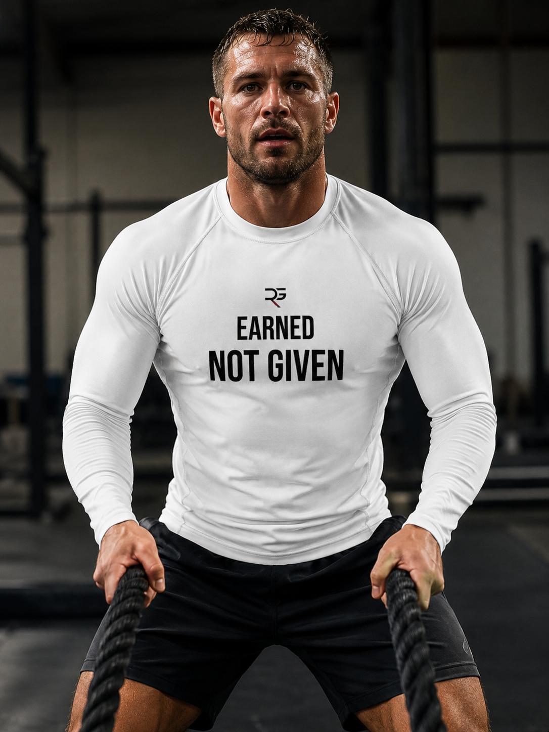 Roll Gear Excuses Don’t Burn Calories Rash Guard – White – Men’s, front view, Earned Not Given chest, during battle ropes.