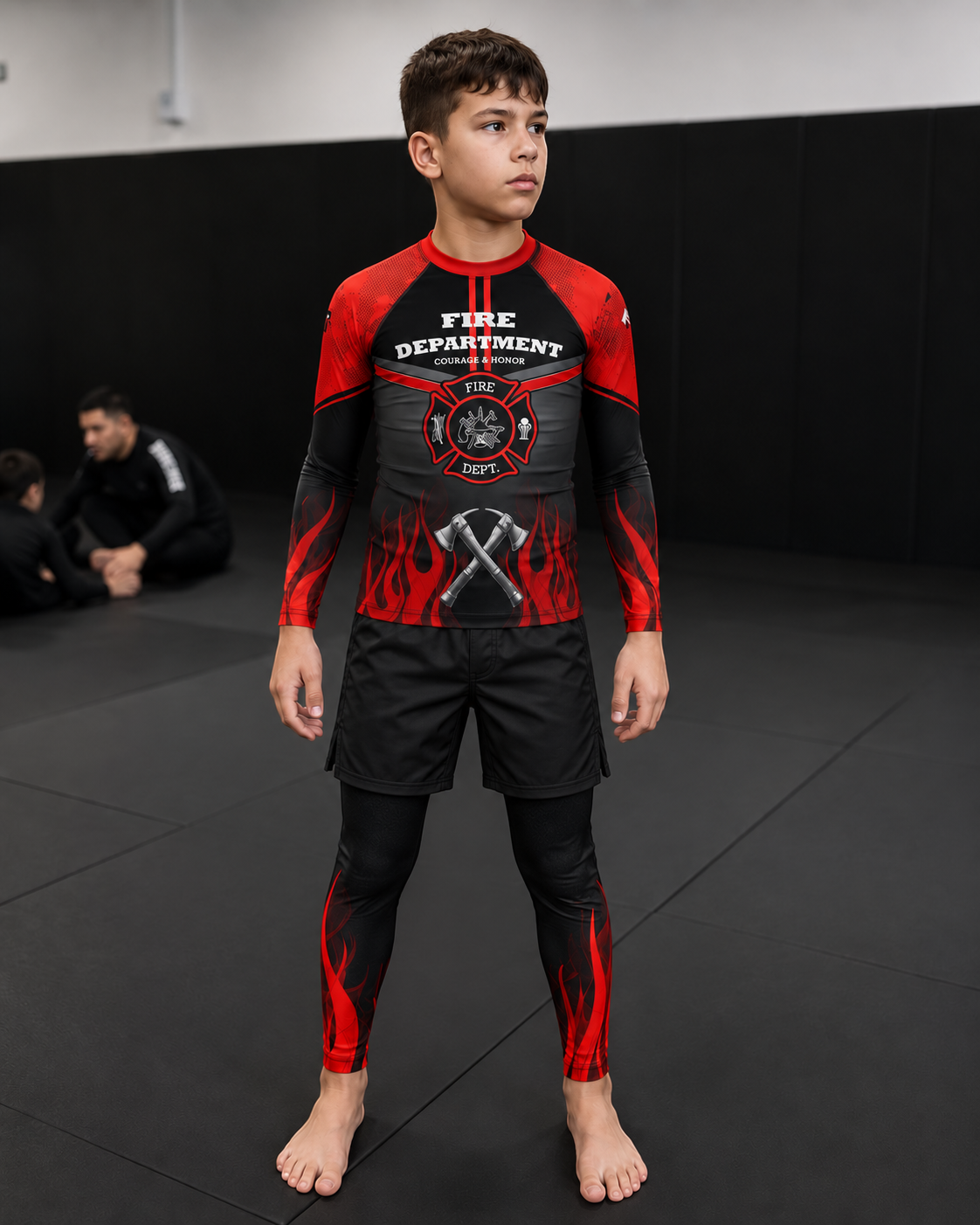 Roll Gear Kids Fire Department Compression Spats – Black with Red Flames, front view on a boy in the matching rash guard.